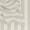 Close-up of beige and white striped fabric from Hawkins New York's Essential Striped Dinner Napkins (Set of 4), draped with soft folds, ideal for relaxed pieces or home basics.