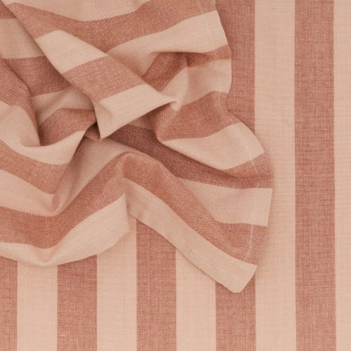 Close-up of crumpled fabric featuring vertical beige and dusty pink stripes from Hawkins New York's Essential Striped Dinner Napkins (Set of 4)—ideal for crafting relaxing designs or enhancing home essentials.