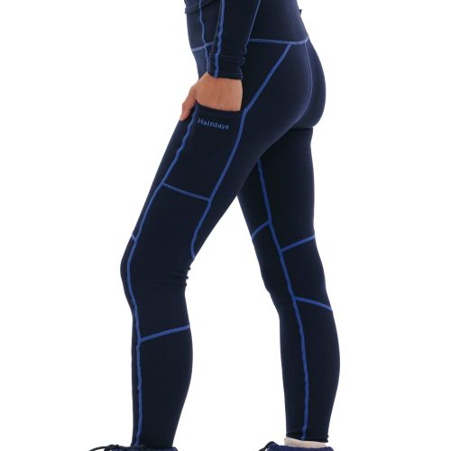 A person is seen from the side wearing Halfdays' Hallie Merino Legging, featuring dark blue fabric with light blue seam details and crafted from a midweight blend of materials.