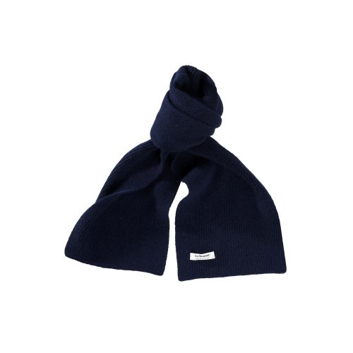 Discover the eco-friendly charm and stylish design of this navy blue knitted lambswool scarf by Le Bonnet, featuring a small white label.