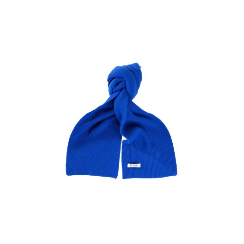 The Le Bonnet lambswool scarf in a vibrant blue, featuring a small white label and tied in a simple knot against a white background, provides both style and biodegradable comfort.